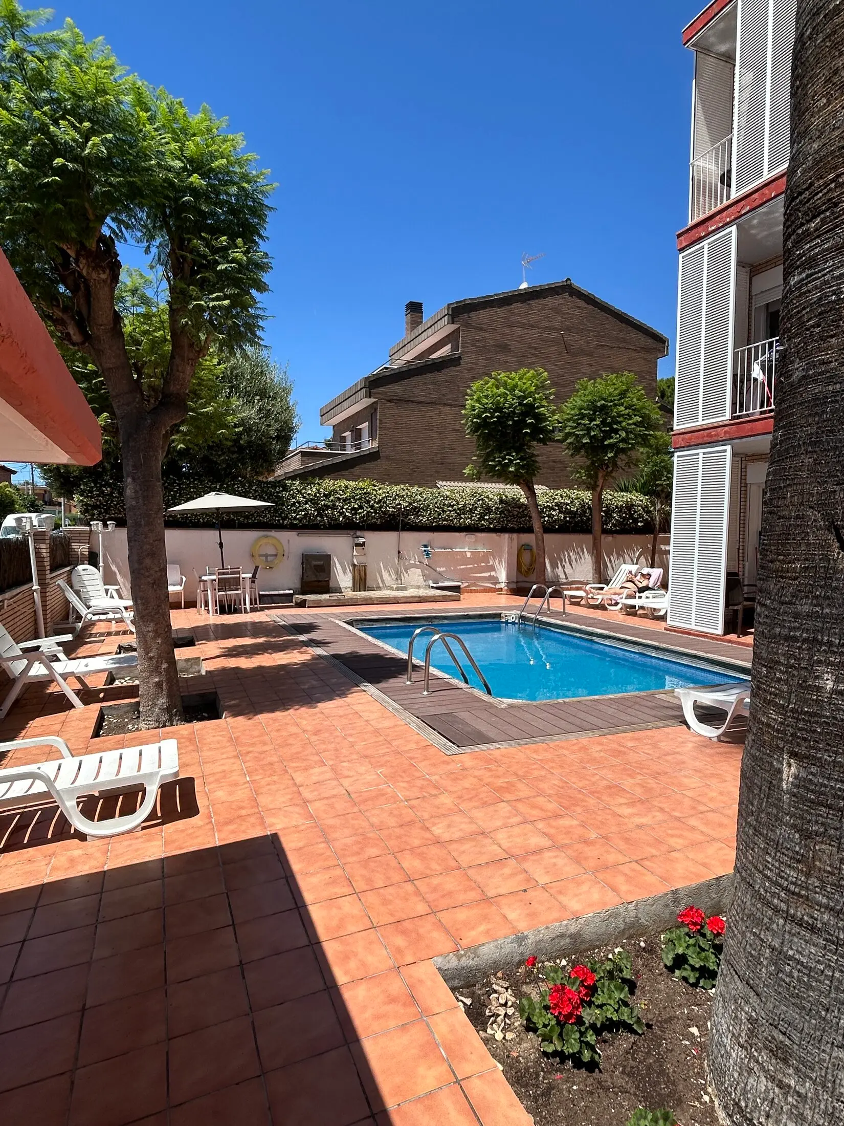 Outdoor pool and garden at Apartamentos ELMA1 in Castelldefels